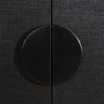 Close-up of a black cabinet knob on a textured black surface