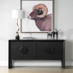 Black cabinet with decorative items and a framed picture of a ram on a white wall.