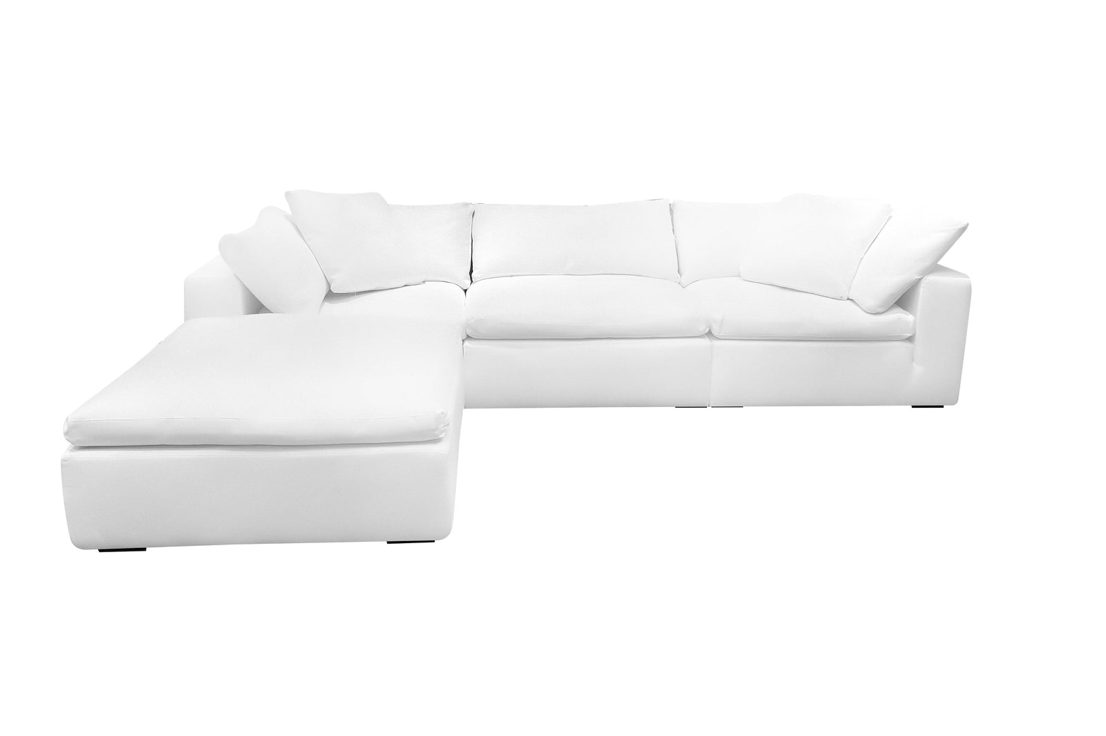A white four-piece modular sectional sofa with deep cushions and wooden legs.