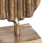 close-up to two gold sculptures on a white background