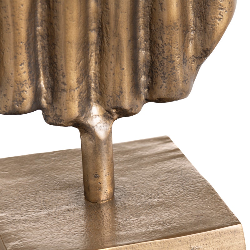 close-up to two gold sculptures on a white background