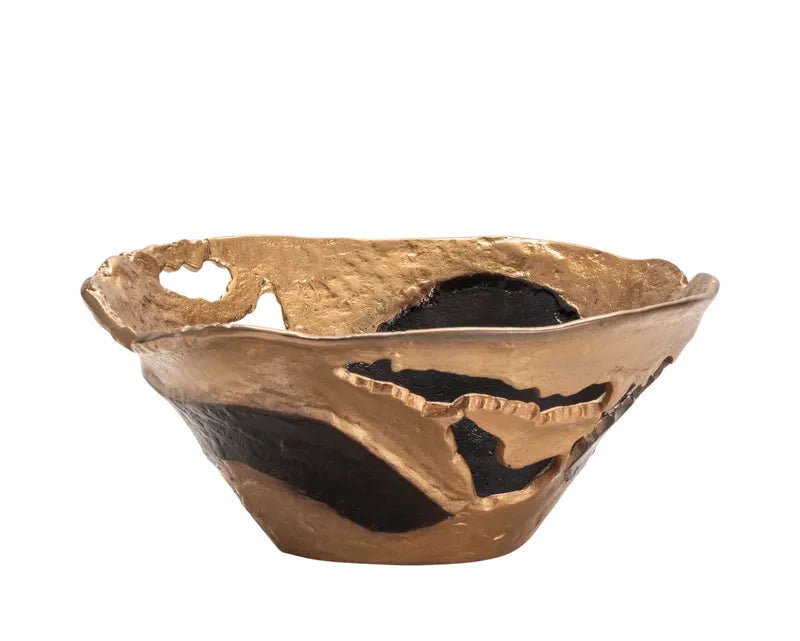 A decorative bowl with a black base color that transitions into a gold tone towards the top.