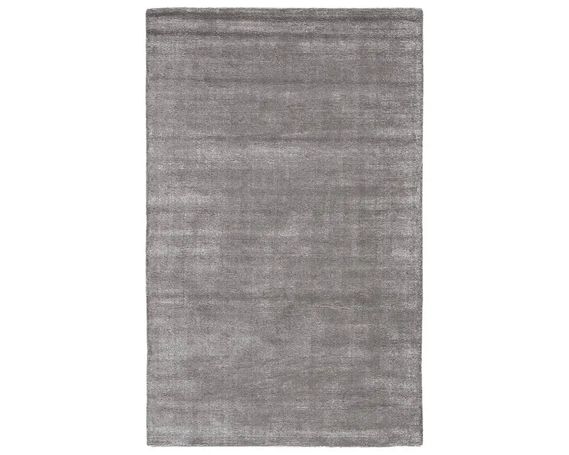 A dark gray area rug with a textured weave, handwoven from a blend of wool and viscose.
