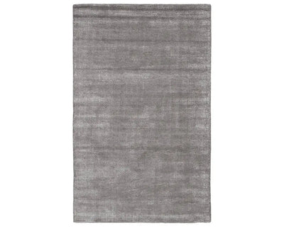 A dark gray area rug with a textured weave, handwoven from a blend of wool and viscose.