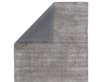 A dark gray area rug with a textured weave, handwoven from a blend of wool and viscose.