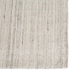 An ivory and gray area rug with a handwoven texture.