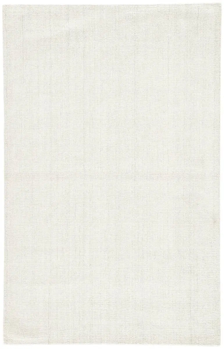 An ivory-colored area rug with a textured weave, partially showing its thickness and material.