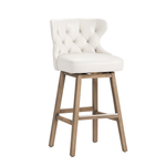 White cushioned bar stool with wooden legs on a white background