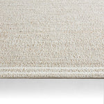 Textured beige rug on a white background
