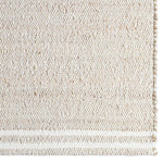 Close-up of a textured beige rug with a subtle pattern