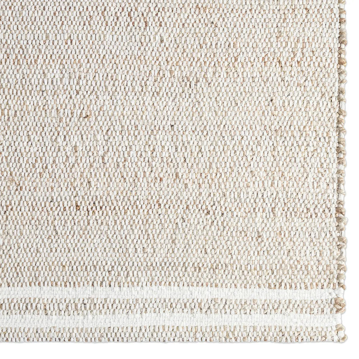 Close-up of a textured beige rug with a subtle pattern