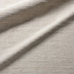 Close-up of textured beige fabric with a subtle pattern