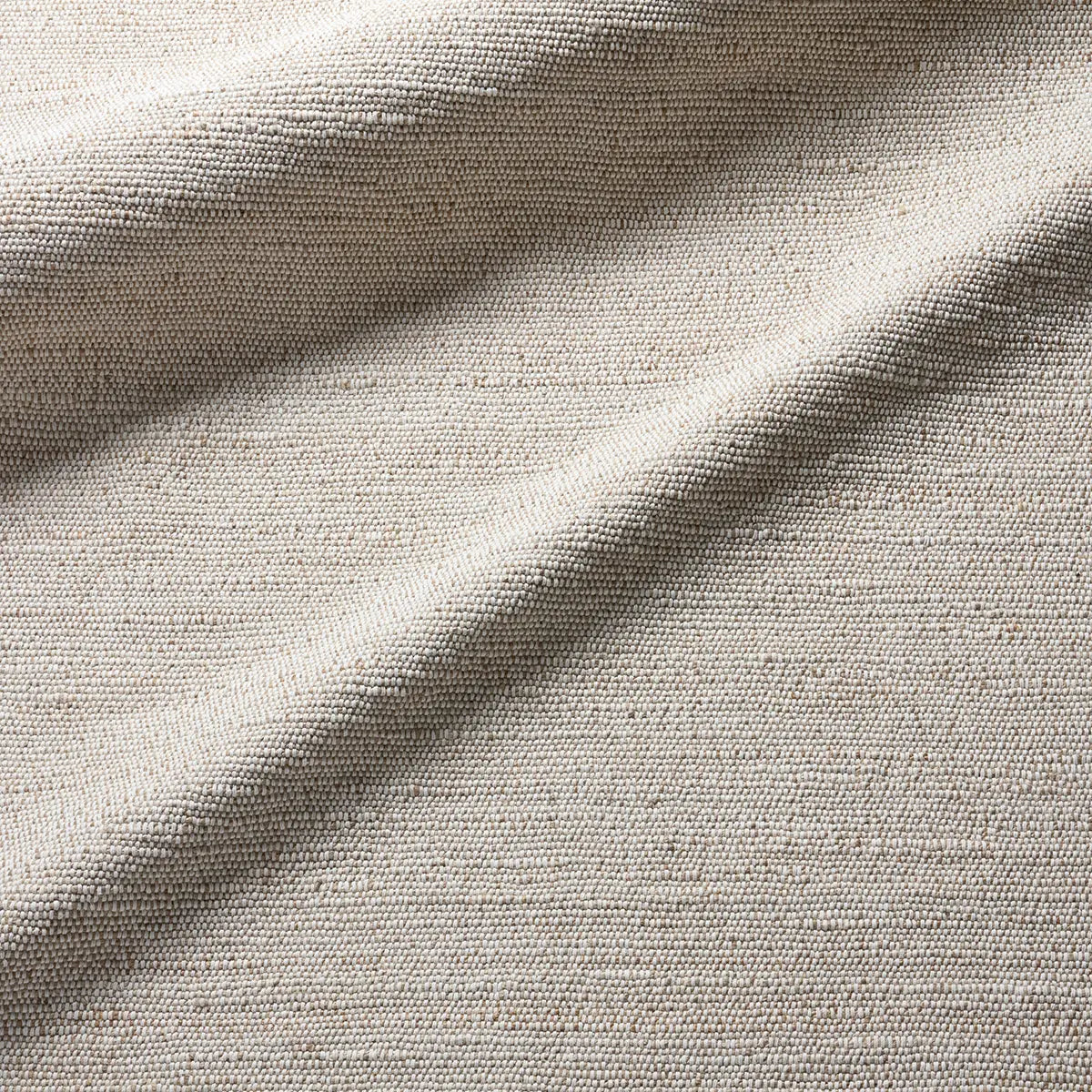 Close-up of textured beige fabric with a subtle pattern