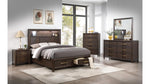 Wooden bedroom furniture set with bed, nightstands, dresser, and mirror in a room with large windows.