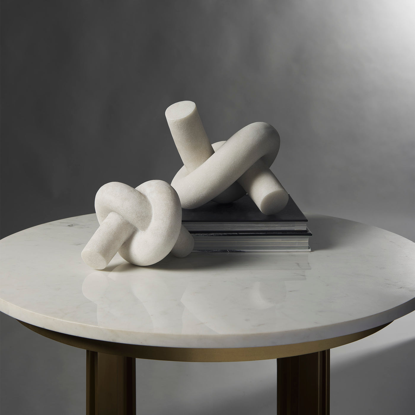 White marble knot sculpture on coffee table