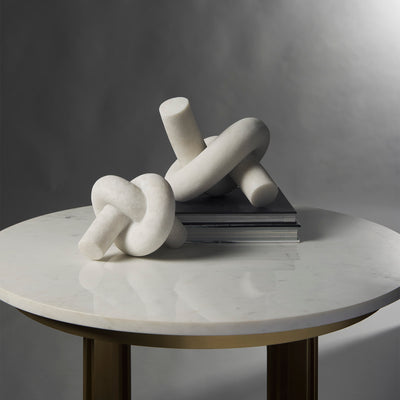 White marble knot sculpture on coffee table