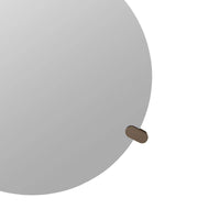 Gray sphere with a small brown object on a white background