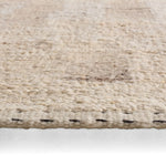 Close-up of a textured beige rug on a white background