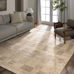 Living room with a textured area rug, gray sofa, and armchair.