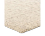 Light beige wool area rug with a hand-tufted texture