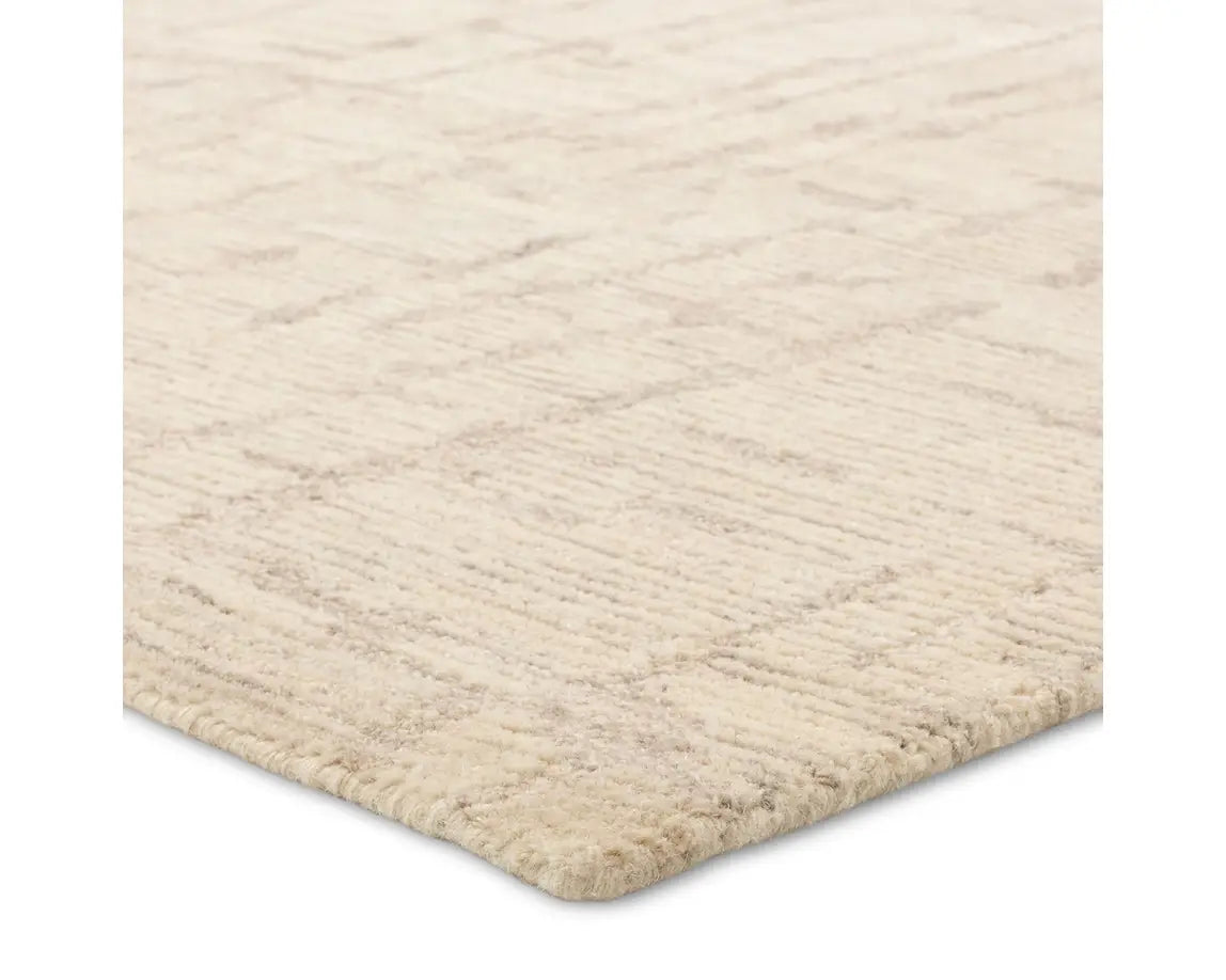 Light beige wool area rug with a hand-tufted texture