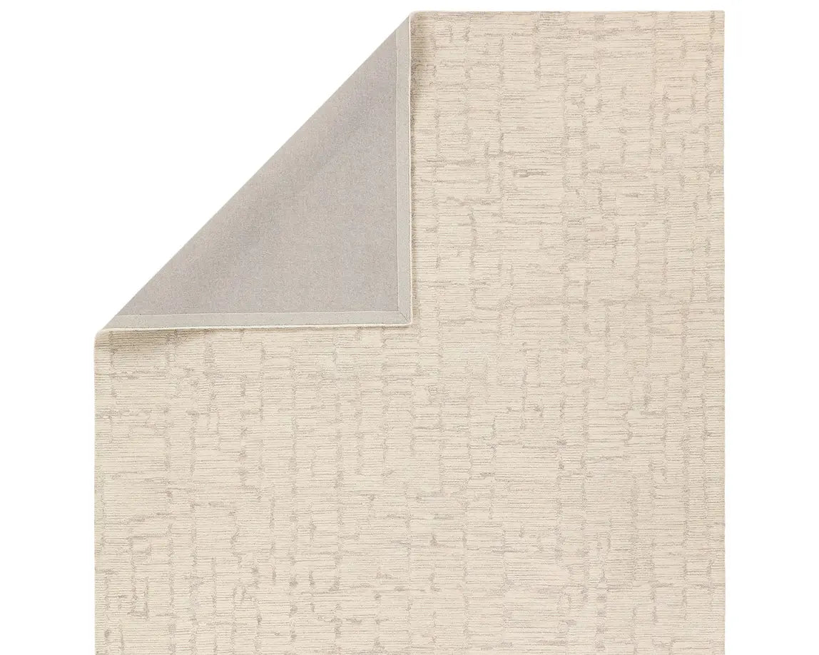 Light beige wool area rug with a hand-tufted texture
