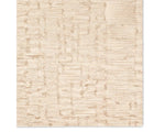 A beige wool area rug with a hand-tufted texture.