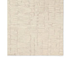 Light beige wool area rug with a hand-tufted texture