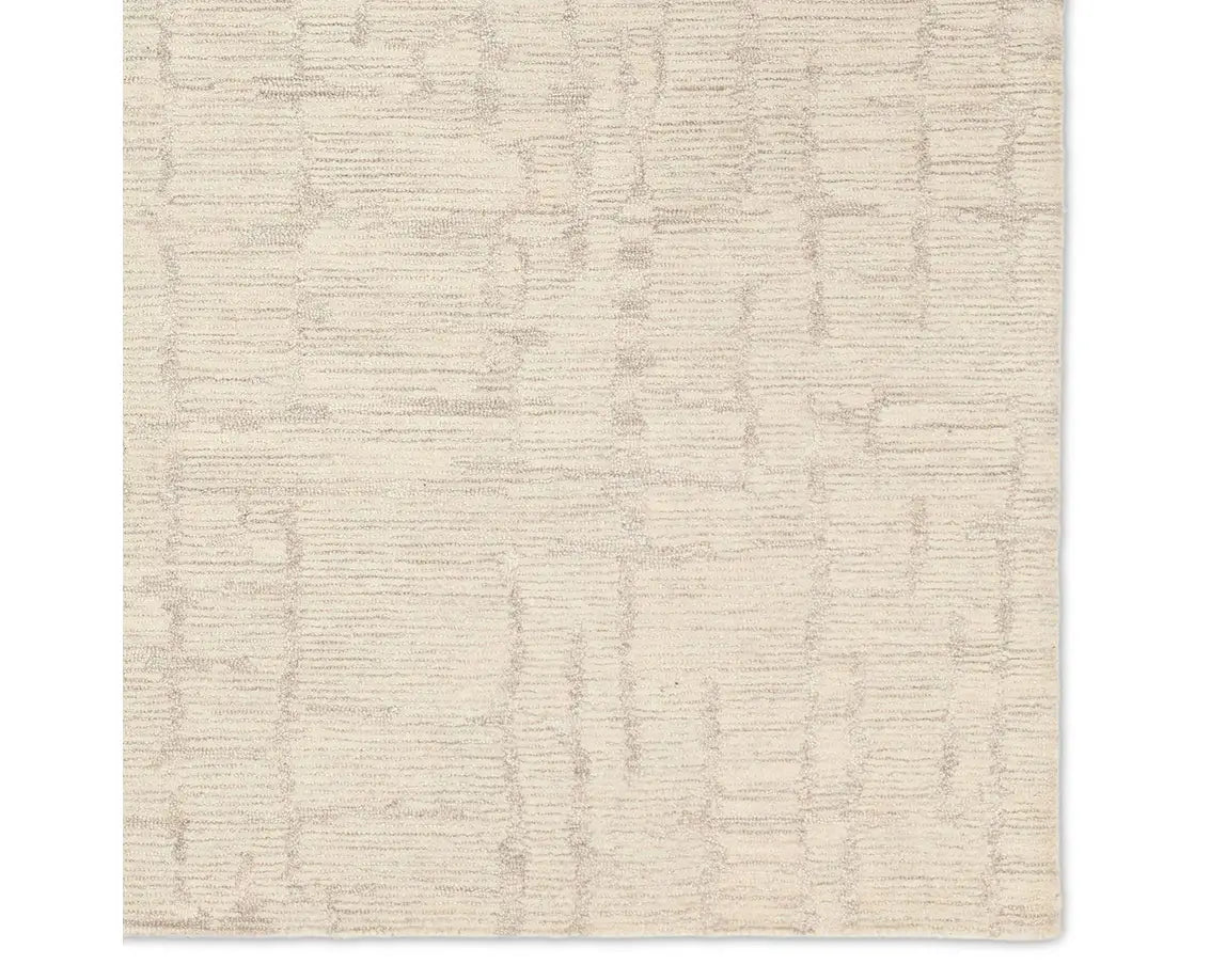 Light beige wool area rug with a hand-tufted texture