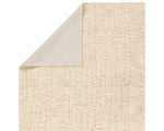 A beige wool area rug with a hand-tufted texture.