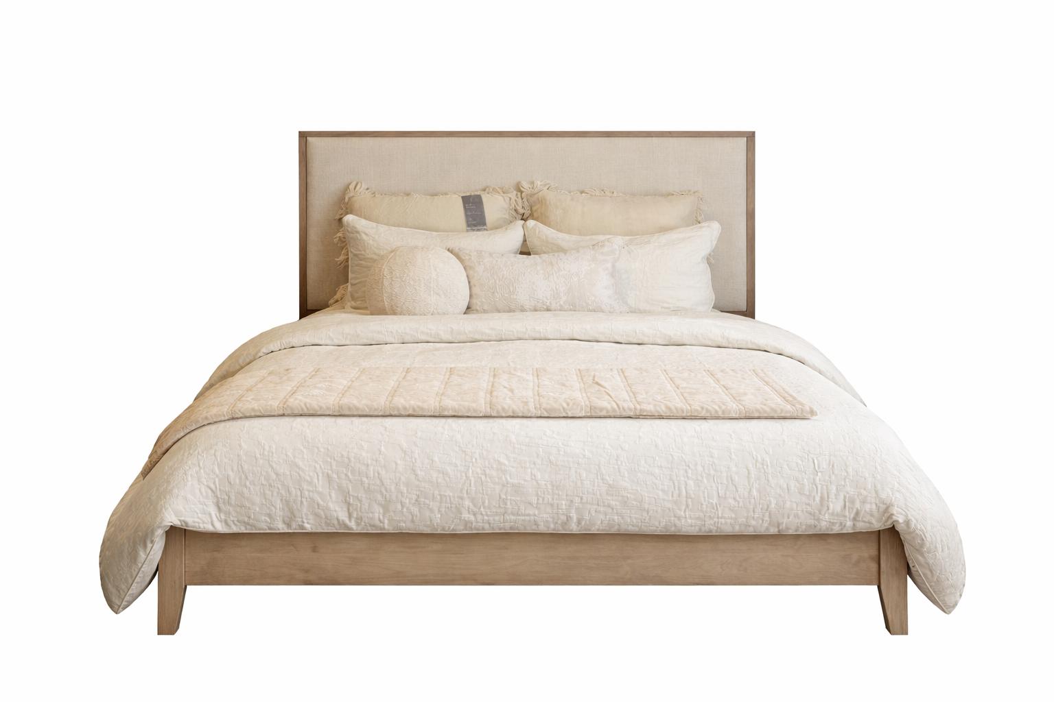 Beige bed with matching headboard and bedding on a white background