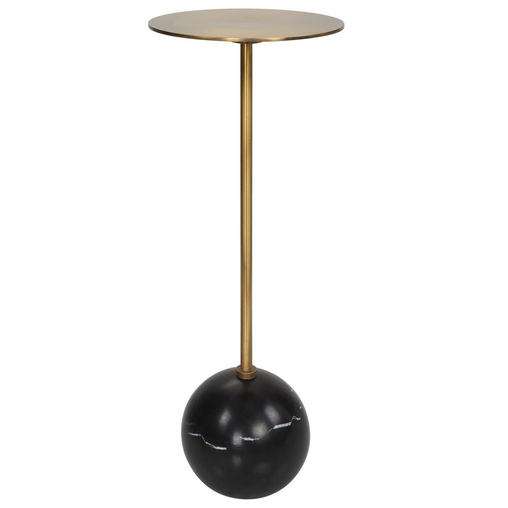 Side table with gold cylindrical top and black spherical base on a white background