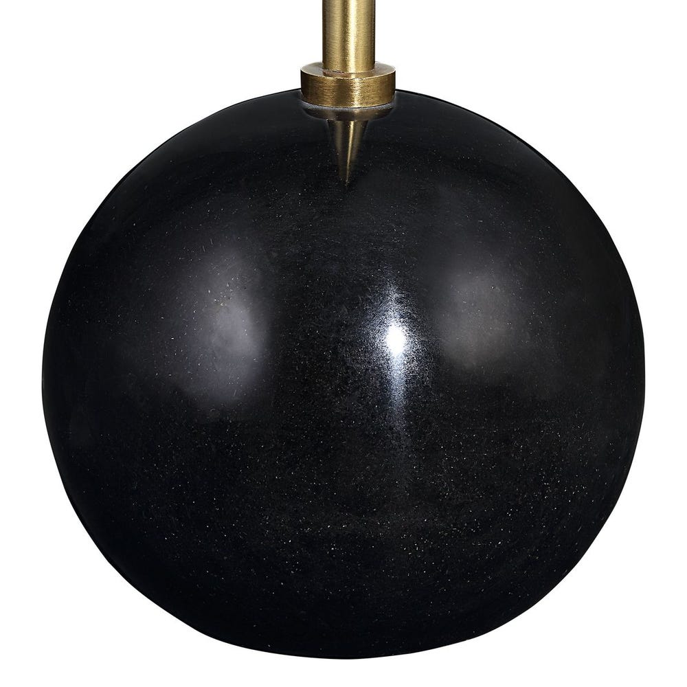Black spherical lamp with brass fixture on a white background