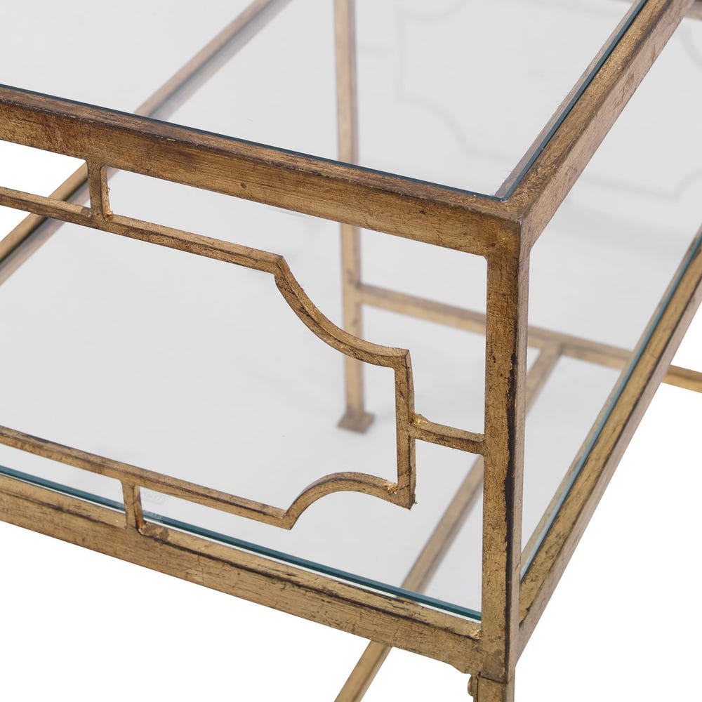 Glass table with gold metal frame on a white background