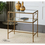 Gold side table with glass top in a room setting