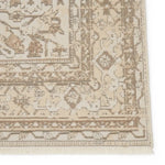 Close-up of a beige and brown patterned rug corner