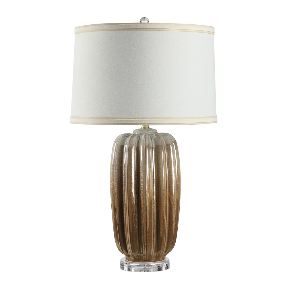 Table lamp with ribbed brown base and white shade on a white background