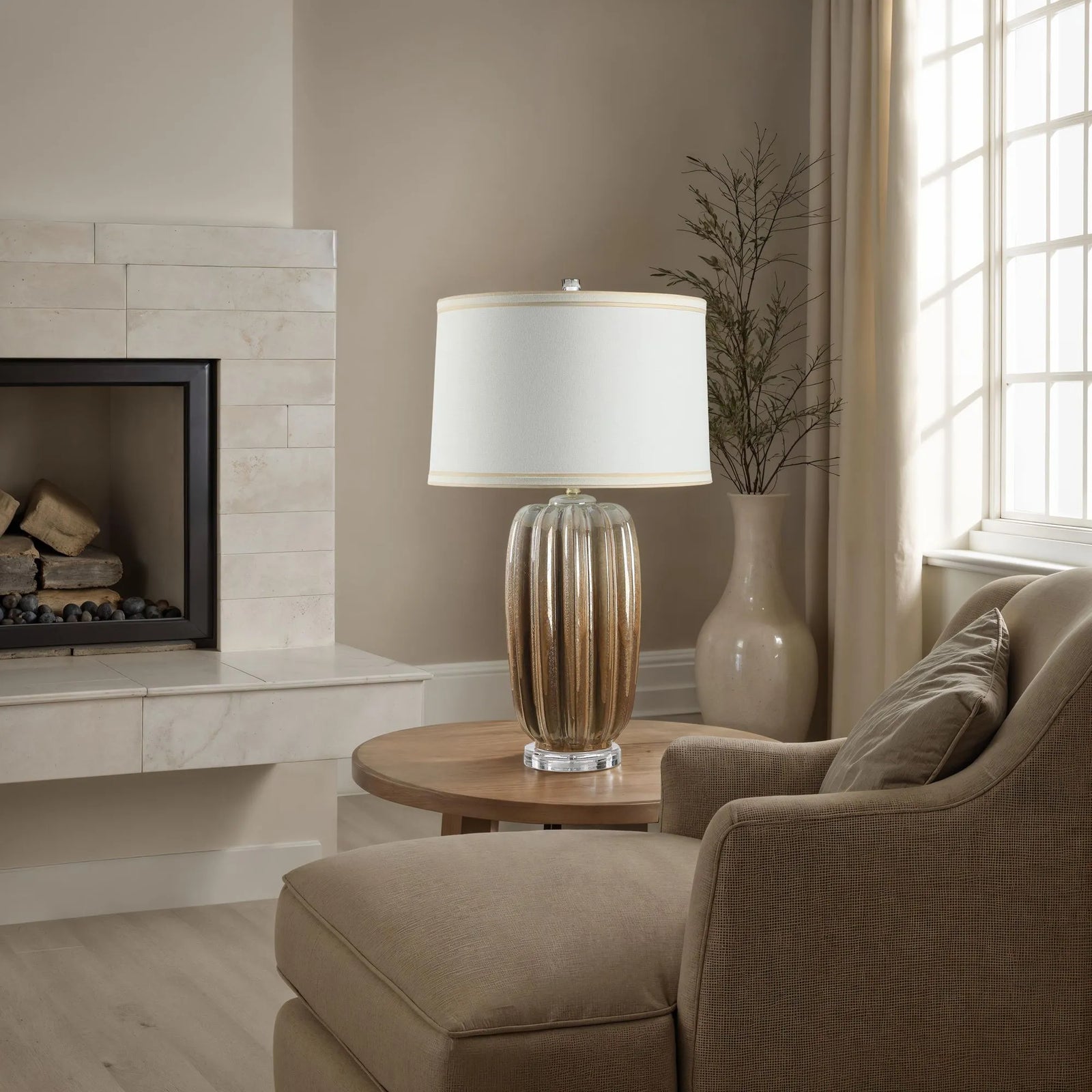 Living room with a beige sofa, lamp, and fireplace.