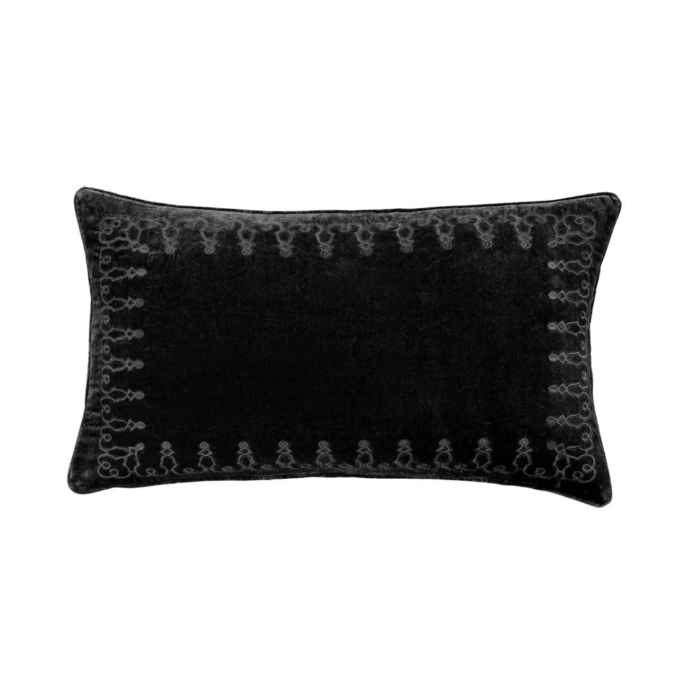 Black decorative pillow with intricate patterns on a white background