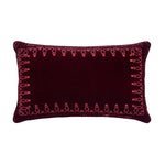 Decorative pillow with pink embroidery on a white background
