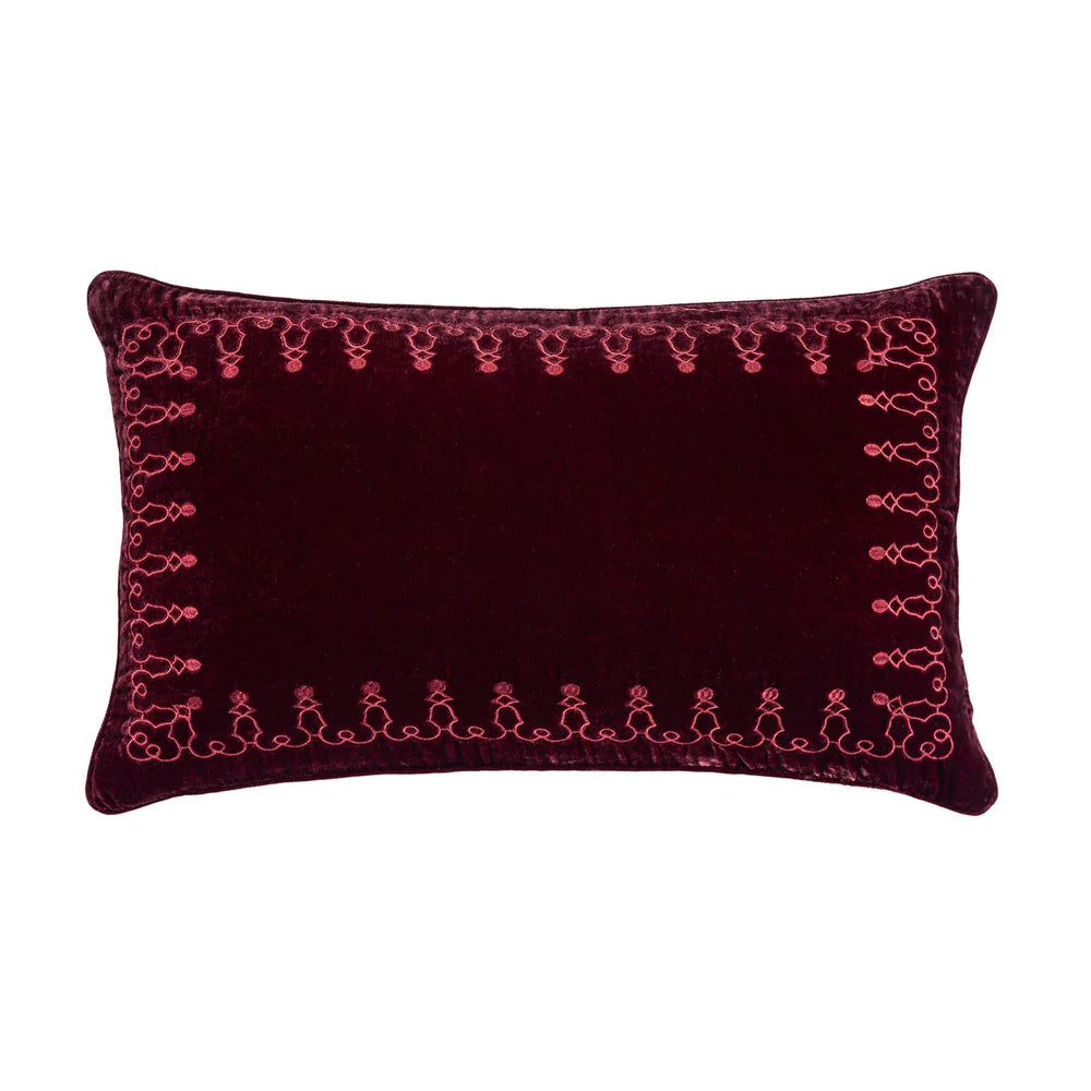 Decorative pillow with pink embroidery on a white background