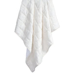 White quilt draped over a white background