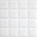 Close-up of a white quilted fabric texture