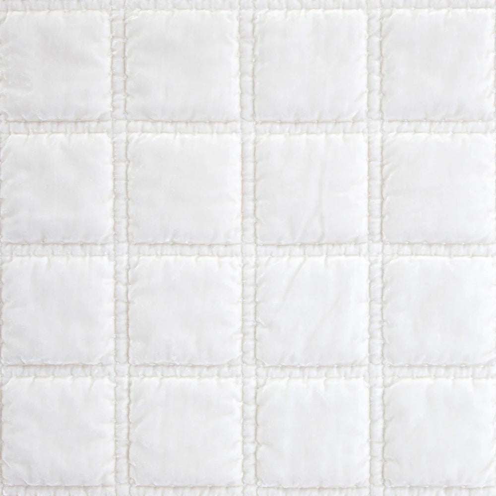 Close-up of a white quilted fabric texture
