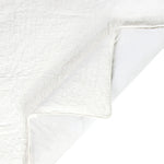 Close-up of a textured white fabric with a subtle pattern