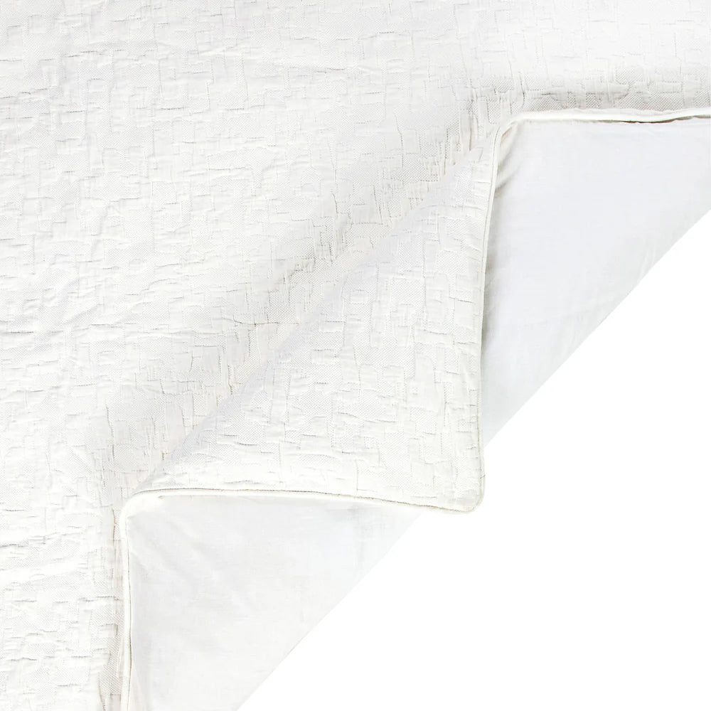 Close-up of a textured white fabric with a subtle pattern