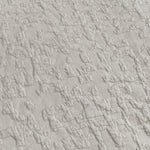 Close-up of textured light gray fabric with a subtle pattern