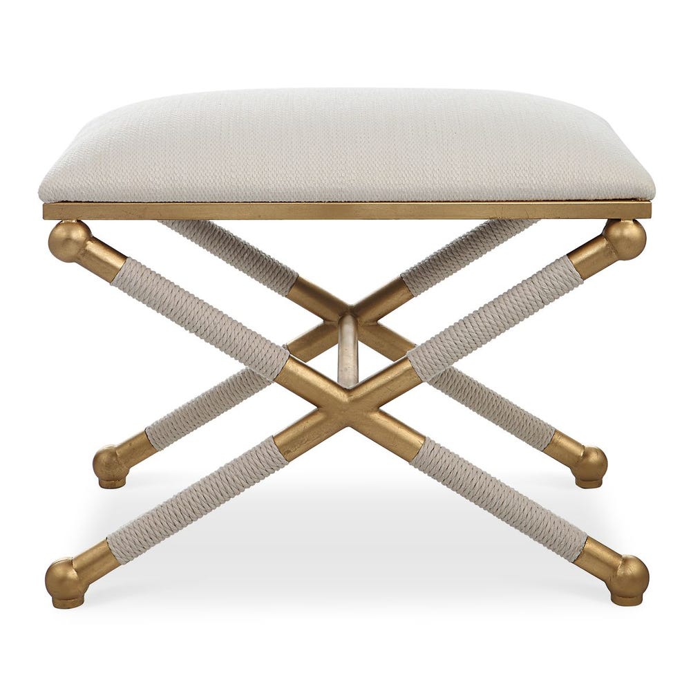 Stool with gold legs and cream cushion on a white background