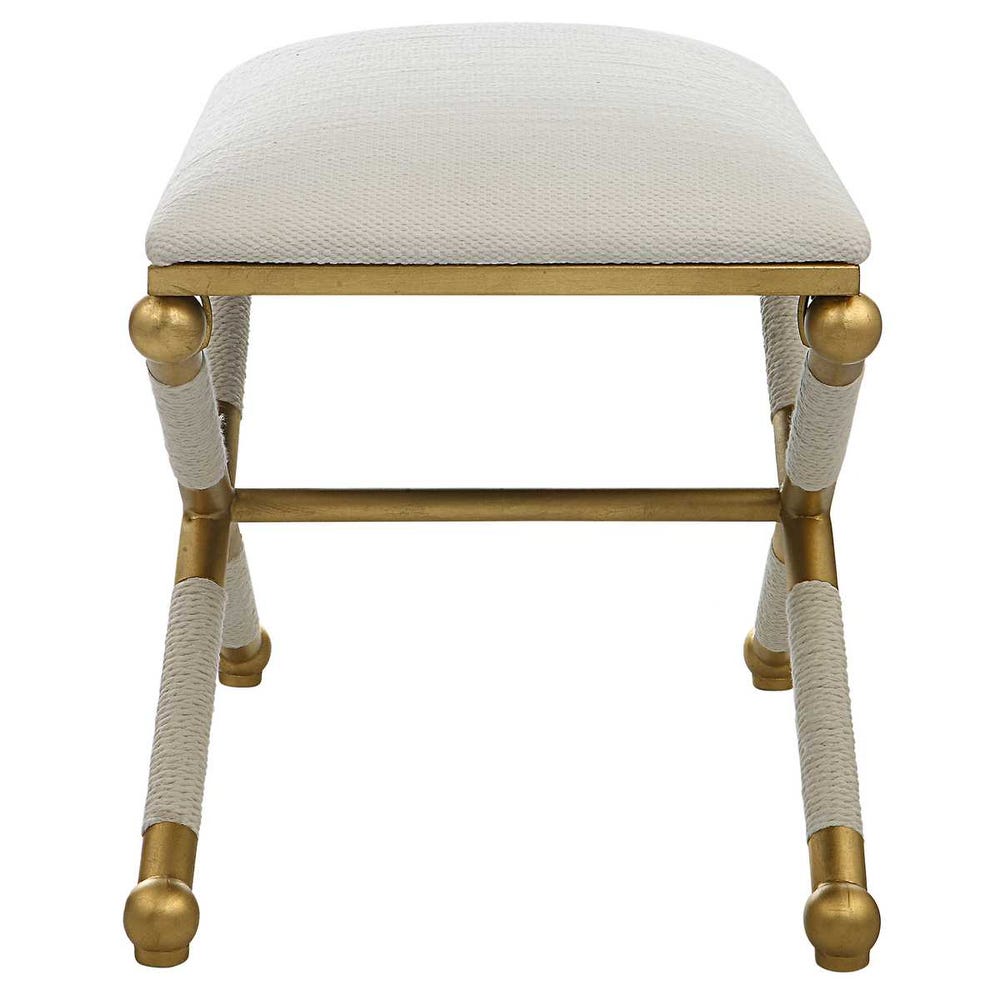Stool with gold legs and white cushioned seat on a white background