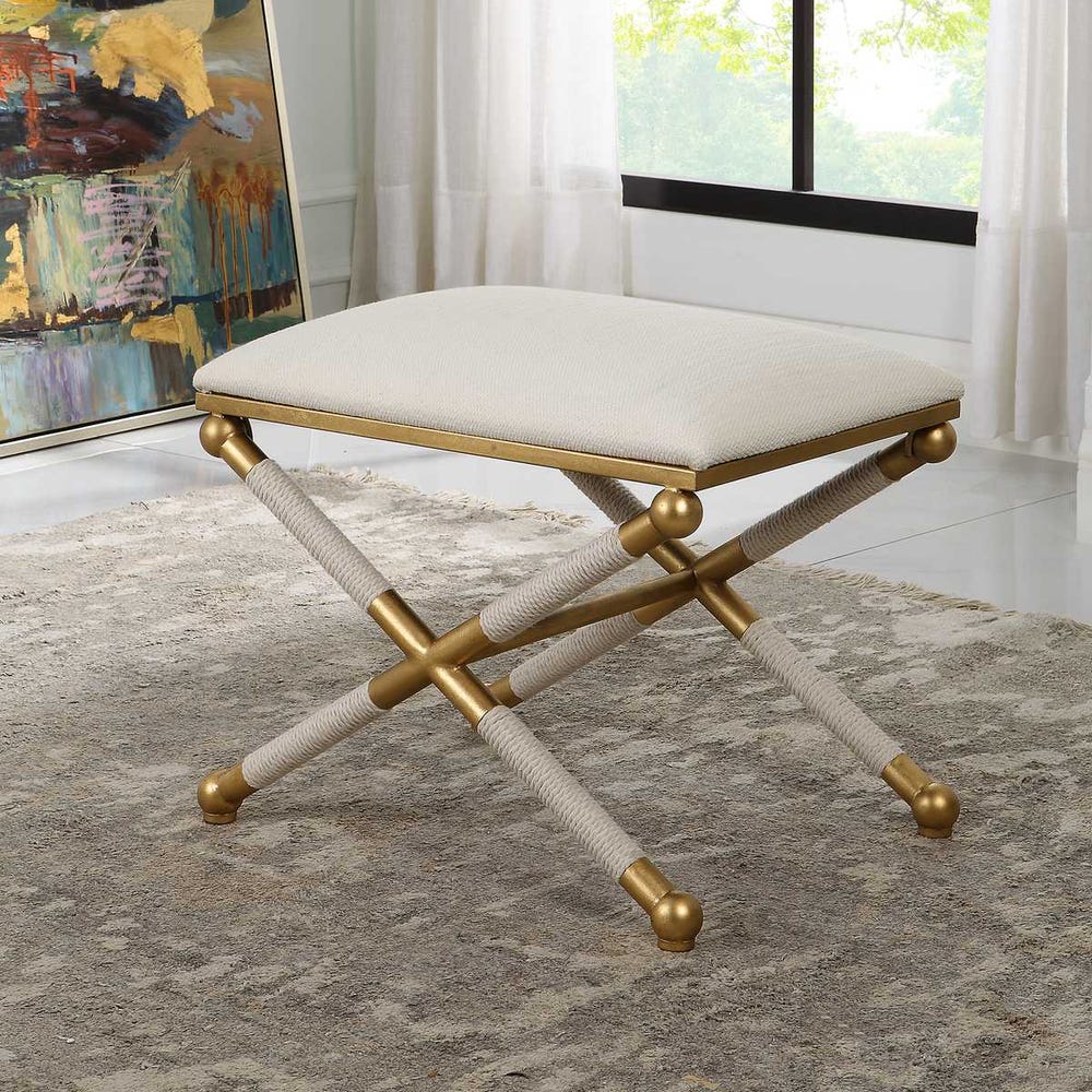 Decorative stool with gold accents on a patterned rug